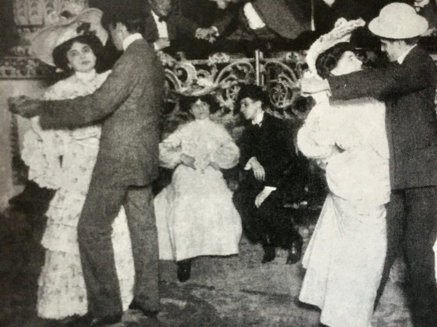 Couples dancing in an early 1900s ballroom